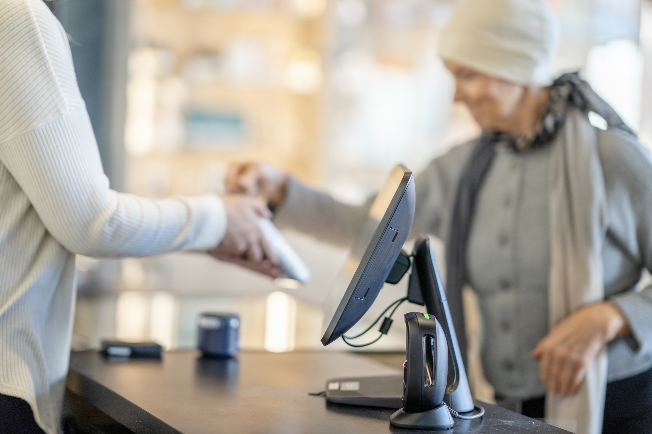 Cancer Patient Tapping Her Debit Card for a Purchase
